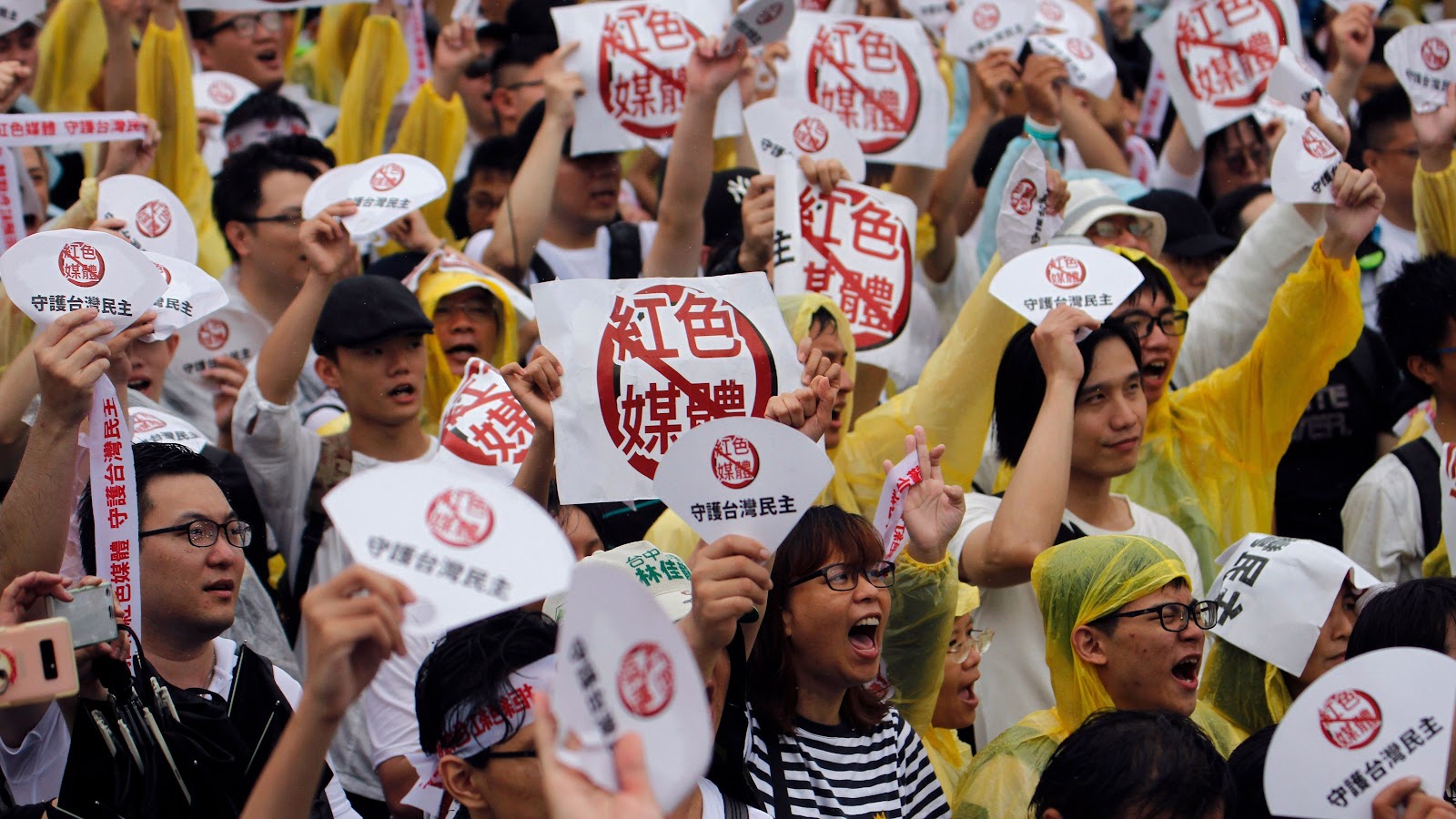 Demonstrators protest against what they call "red media" influence in Taiwan during a rally against pro-China media in front of the president's office building in Taipei on June 23.