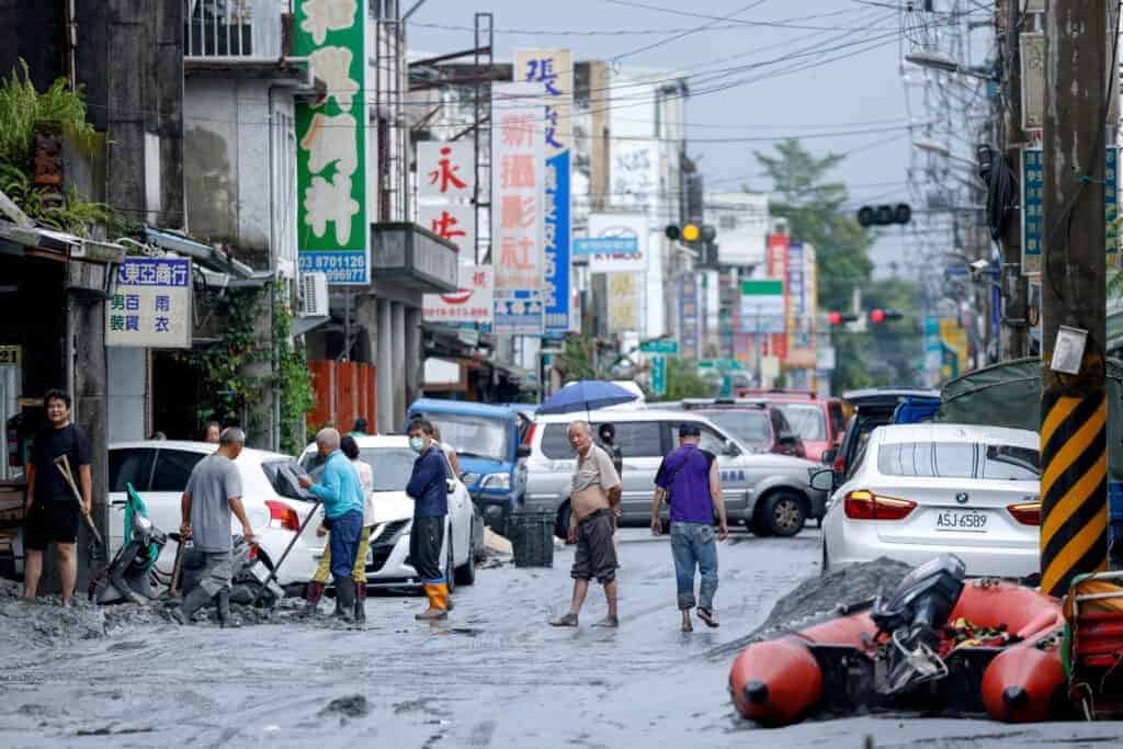 People clean mud from a street following flooding brought by Super Typhoon Ragasa in Hualien. (TOP Image/ Reuters/ Ann Wang)